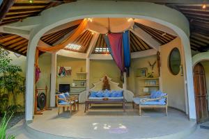 a living room with a couch and a table at Ben Bali Villa in Seminyak