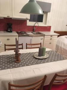 a kitchen with a table with a table cloth on it at Långesjö lillstuga in Fjällbacka