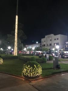 a pole with lights in a park at night at Hotel Vila Real Rex in Poços de Caldas