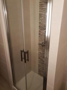a shower with a glass door in a bathroom at Beautiful Old property in Bordeaux Center in Bordeaux