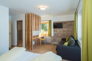 a bedroom with a couch and a living room at Apartment Alpenperle in Schladming