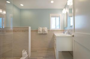 a bathroom with a shower and a toilet and a sink at Sea Crest in Amagansett +269 photos