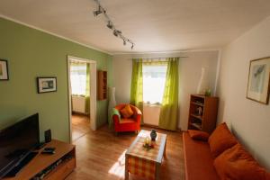 a living room with a couch and a chair at flat2let Apartment 1 in Frankfurt/Main