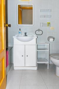 a white bathroom with a sink and a toilet at Irtaplaya 310 in Alcossebre