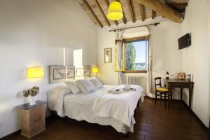 a bedroom with a bed and a table and a desk at Podere Scaluccia in Impruneta