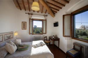 a bedroom with a bed and a large window at Podere Scaluccia in Impruneta