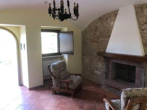 a living room with a chair and a fireplace at La Sorgente Alta in Rocchetta a Volturno