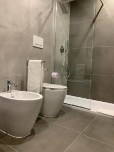 a bathroom with a shower and a toilet and a sink at ApartHotel Bossi in Milan