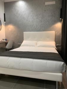 a bedroom with a white bed and a desk at ApartHotel Bossi in Milan