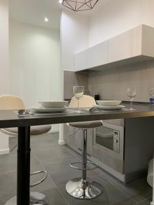 a kitchen with a counter with two wine glasses at ApartHotel Bossi in Milan