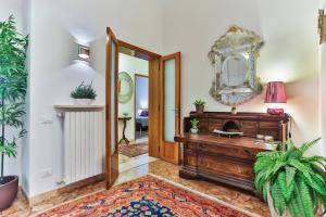 a hallway with a mirror and a wooden dresser at Cà Mocenigo Nobile in Venice