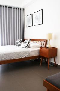 a bedroom with a bed and a table with a lamp at Scandinavian Asia Afrika in Bandung