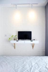 a living room with a tv on a white wall at Scandinavian Asia Afrika in Bandung