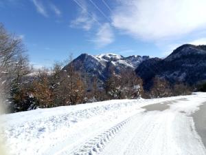 a snow covered road with mountains in the background at Art Deco Bed & Breakfast in Dikorfo