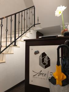 a staircase with a sign for aace boutique at Arce Boutique in Braşov