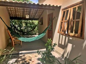 a hammock on the outside of a house at Village Mata Encantada in Santo André