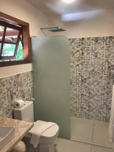a bathroom with a shower and a toilet and a sink at Village Mata Encantada in Santo André