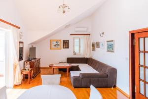 a living room with a couch and a table at Mediterranean Blue Apartments in Dubrovnik