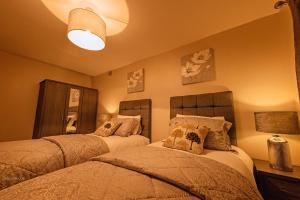 a bedroom with two beds and a lamp at Birmingham Apartments Yardley B, BHX, NEC & City Centre in Birmingham