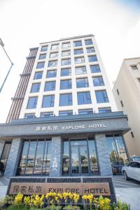 a hotel building with a sign in front of it at Explore Hotel in Taichung