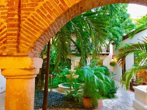 a courtyard with palm trees in a building at Paseo Colonial - El Monasterio #4 in Santo Domingo