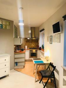 a kitchen with a table and a desk in it at Apartament Centrum in Zielona Góra