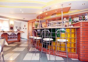 a bar with chairs and a counter in a restaurant at Apartamenty Rok in Kołobrzeg