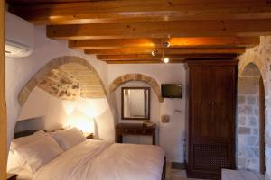 A bed or beds in a room at Likinia Hotel