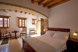 A bed or beds in a room at Likinia Hotel