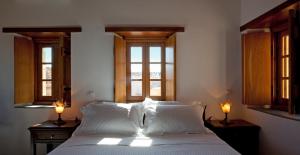 A bed or beds in a room at Likinia Hotel