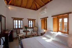 A bed or beds in a room at Likinia Hotel