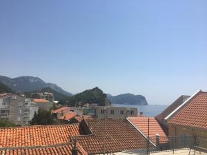 a view of a city with houses and the ocean at Fisherman's Apartment in Petrovac na Moru