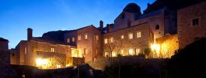 a large building with lights on it at night at Likinia Hotel in Monemvasia