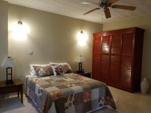 a bedroom with a bed and a ceiling fan at Casa Vista in Marigot Bay +83 photos