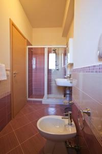 a bathroom with a sink and a toilet and a shower at Erice Mare in Erice
