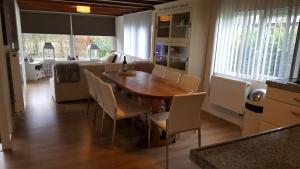 a dining room with a wooden table and chairs at Patrijshof 6 - 8 personen in Baarle-Nassau