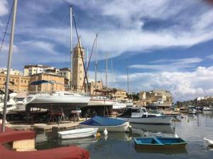 a group of boats are docked in a harbor at Ocean View, Apartment 1 in Marsaskala