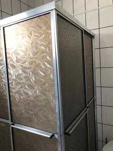a shower with a glass door in a bathroom at Casa para temporada in Governador Celso Ramos