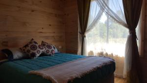 Una cama o camas en una habitación de Rustico Pucon
