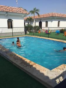 a group of people swimming in a swimming pool at Jeddah Wakan Villas in Jeddah