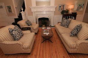 a living room filled with furniture and a fireplace at Anchor Inn Beach House in Provincetown