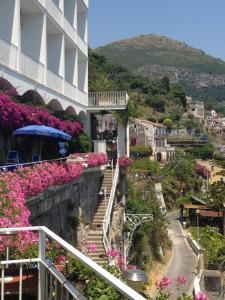 a view of a building with flowers on a hill at Hotel Voce del Mare in Vietri sul Mare