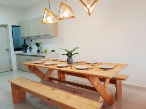 una mesa de madera con platos en la cocina en S3 The Wood @ The Best Location at Puchong, en Puchong