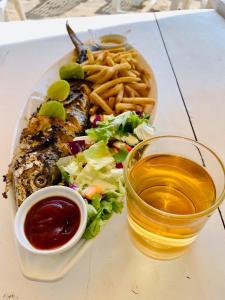 a plate of food with a salad and french fries at Ashford Beach in Matara