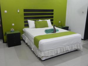 Postel nebo postele na pokoji v ubytování Blue Gecko West Bali