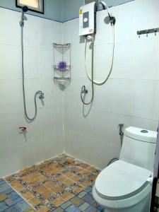 a bathroom with a shower and a toilet in it at Chawlay Resort Koh Lipe in Ko Lipe
