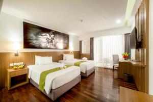 A bed or beds in a room at New Garden View Resort - CHSE Certified