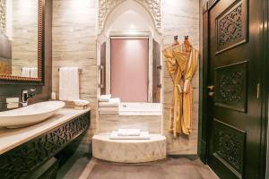 a bathroom with a sink and a tub at Zabeel Saray Royal Residences Lagoon Villa in Dubai