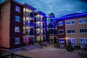 a group of buildings with purple lights on them at Red Sox Hotel Ltd in Kampala