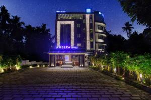 a night view of a hotel at night at Ambara Suites in Trivandrum